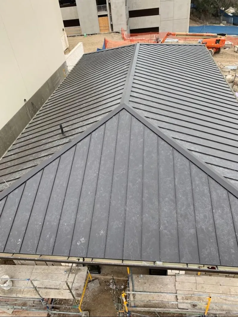 Commercial metal roof construction with crane equipment in Platteville