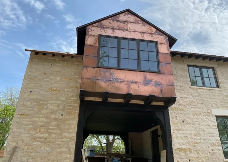Copper metal panel facade on a stone building for Skylight Installation in Platteville